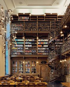 an image of a library with many books on the shelves and stairs leading up to it