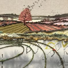 an embroidered landscape with trees and birds in the distance, on top of a hill