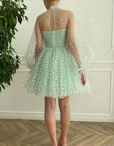 Indulge in the magic of our "Gemma" homecoming dress. Crafted from light, heart-shaped dot tulle fabric, dress Gemma radiates a unique charm that's impossible to ignore. The dress comes with an illusion corset bodice that accentuates your figure and provides a flattering silhouette. It features a high-neck illusion neckline, adding an alluring element to the outfit. This stylish feature is perfectly complemented by long puffy sleeves, balancing contemporary style and traditional elegance. Whethe Brithday Dress, Simple Evening Gown, High Neck Prom Dress, Mode Tips, Mint Green Dress, Mini Homecoming Dresses, Green Tulle, Prom Dresses Gowns, Dress Tulle