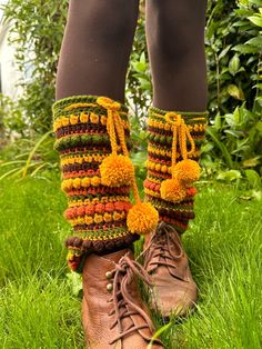 the legs are decorated with multicolored crocheted socks and boot covers, along with brown boots