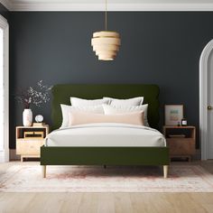 a bedroom with a green headboard and white sheets on the bed, two nightstands next to each other