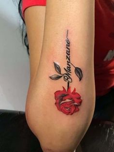 a woman with a rose tattoo on her arm