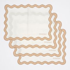 three napkins with words on them sitting next to each other in front of a white background