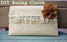 an old burlap clutch with a flower on the front and lace around it