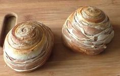 two pieces of bread sitting on top of a wooden cutting board next to each other