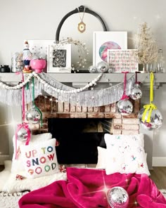 a living room with a fire place and christmas decorations on the mantel above it