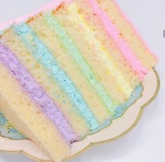 a slice of rainbow cake sitting on top of a plate