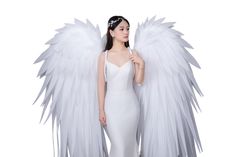 a woman in a white dress with angel wings