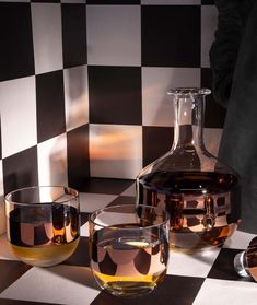 three glasses and a decanter on a checkered table