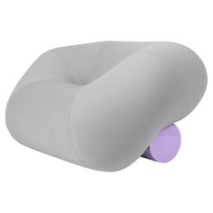 a gray and purple pillow sitting on top of a white floor