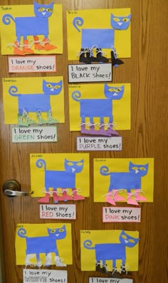 the door is decorated with paper cut outs and pictures of cats on them, all in different colors