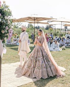 the bride and groom are standing under an umbrella at their outdoor wedding ceremony in india