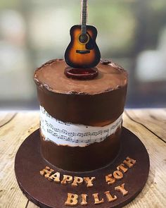 a birthday cake with a guitar on top