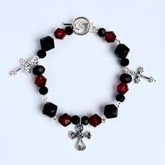 Black and Red gothic beaded bracelet with Cross charms. This bracelet was made with care to fit the alternative aesthetic, specifically romantic goth and mall goth, or any style or outfit matching black or red. The bracelet closes with a toggle clasp for easy wear. Length - 8 inches This product is handcrafted and will be packaged in a small, black organza bag to compliment the dark aesthetic of the bracelet. Goth Bracelets, Gothic Beaded Bracelet, Adjustable Gothic Bracelet For Streetwear, Adjustable Gothic Bracelet, Gothic Black Beaded Bracelets, Black Beaded Gothic Bracelets, Alternative Aesthetic, Red Gothic, Romantic Goth