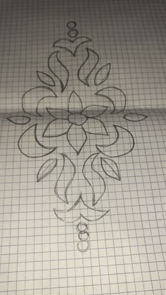 a piece of graph paper with a drawing of a flower in the center on it