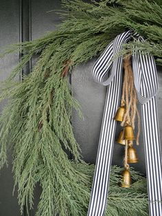 a christmas wreath with bells hanging from it