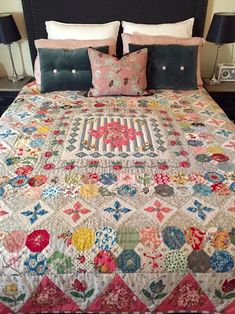 a bed with a quilt and pillows on it