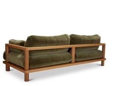 a green couch sitting on top of a wooden frame