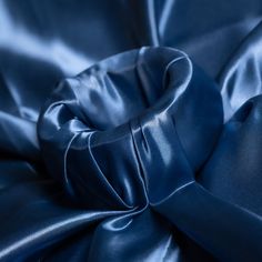 The bridal satin fabrics are exceptionally shiny with a silky soft satin feel. Navy Blue in the bridal satin are vibrant and glossy due to its smooth polished composition. The satin side captures the light in a bold manner, demanding attention. The back of the fabric has a modest matte finish, allowing you to easily handle the fabric while sewing. With a unique sturdy body and soft drape its a versatile fabric used in a variety of apparel and craft projects. The fabric's gleaming colors are ofte Blue Satin Dress For Wedding With Satin Finish, Formal Solid Color Satin Dress, Blue Silk Satin Wedding Dress, Blue Satin Dress For Wedding, Blue Satin Wedding Dress, Formal Silk Satin Dress, Solid Color Silk Satin Dress, Tablecloth Dress, Elegant Tablecloth