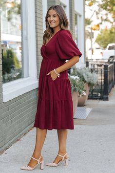 Flowy and effortlessly chic, the Wine Tiered Midi Wrap Dress is perfect for those seeking a boho-inspired look with elegant flair! Its rich color and flattering silhouette make it a must-have for any occasion. With its wrapped front design, this dress cinches at the waist for a customizable and figure-enhancing fit. Pair it with boots or heels for a versatile look that transitions effortlessly from day to night. Fall Dresses With Boots, Dresses With Boots, Fall Style Guide, Gameday Dress, Loungewear Dresses, Casual White Dress, Midi Wrap Dress, Game Dresses, Boots Ankle