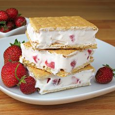 two strawberries and cream sandwiches on a white plate with the caption strawberries and cream sandwiches graham crackers, cool whip and sliced strawberries freeze and they make a great little snack want some