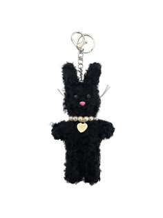 a black teddy bear keychain with a heart on it's chest and pearls around the neck