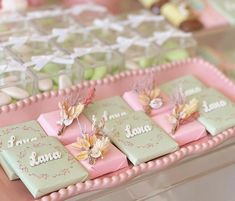 there are many small pieces of cake on the trays that have flowers on them