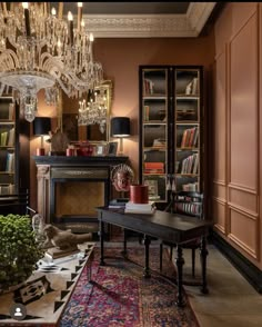 a living room filled with lots of furniture and a chandelier hanging from the ceiling