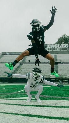 two football players are jumping in the air