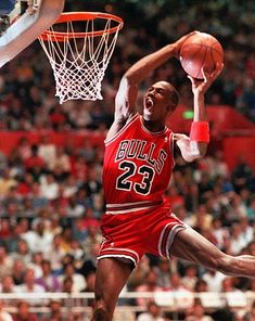 a basketball player jumping up to dunk the ball