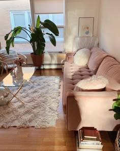 a living room with a couch, chair and rug in front of a large window