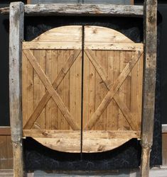 a large wooden gate with two doors on each side