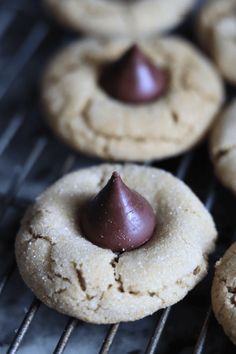 some cookies are cooling on a rack with chocolate