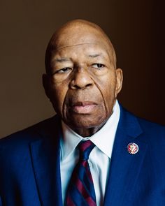 an older man wearing a blue suit and tie