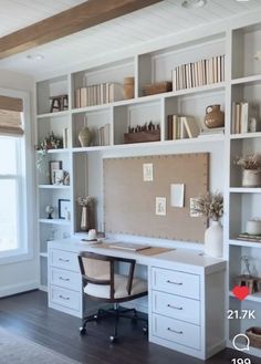 a home office with white bookcases and drawers