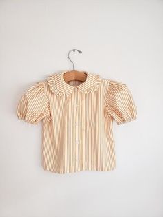 Ruffle Peter Pan collar shirt with puffy sleeves for toddler girls❤Made to order. Vintage inspired shirt, perfect for any occasion.  Made of 100% cotton shirting fabric in your choice of yellow, pink, black and white, and rainbow stripes.❤Buttons may vary.☆☆ Listing is for the shirt only☆☆▪︎Matching pieces here▪︎https://www.etsy.com/shop/CeciliaAndMae?ref=simple-shop-header-name&listing_id=678216147&section_id=26035288•More shirt options here•https://www.etsy.com/shop/CeciliaAndMae?ref=s Yellow Puff Sleeve Top With Ruffles, Cute Yellow Fitted Blouse, Cute Collared Blouse With Ruffles, Cute Tops With Ruffled Collar, Spring Playful Puff Sleeve Tops, Playful Puff Sleeve Tops For Spring, Spring Puff Sleeve Playful Tops, Striped Short Sleeve Blouse With Ruffles, Yellow Cotton Puff Sleeve Tops