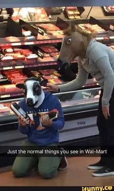 a woman standing next to a dog in a store