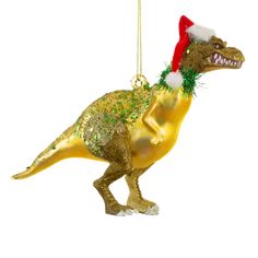 a gold dinosaur ornament with a santa hat on it's head hanging from a chain