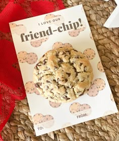 a chocolate chip cookie sitting on top of a card