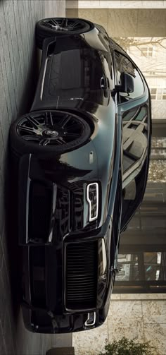 a black sports car parked in front of a building