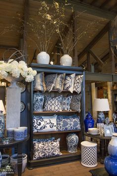 a room filled with lots of blue and white vases