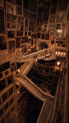 the stairs are made of wood and have many pictures on them in an old building