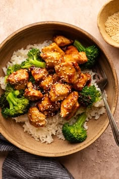 a bowl filled with chicken and broccoli on top of rice