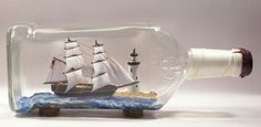 a ship in a bottle on a white surface