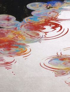 an abstract painting with red, white and blue circles in the water on a black background