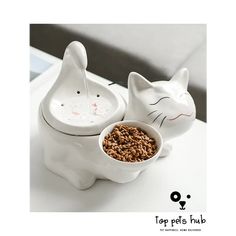 a white cat shaped bowl with cereal in it