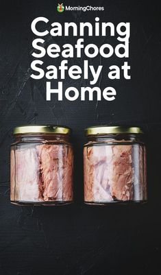 two jars filled with food sitting on top of a black table next to each other