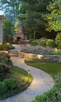 an outdoor patio with stone steps and landscaping