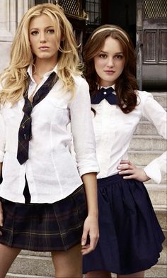 two young women dressed in school uniforms posing for the camera with their hands on their hipss