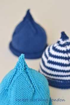 three knitted hats sitting next to each other